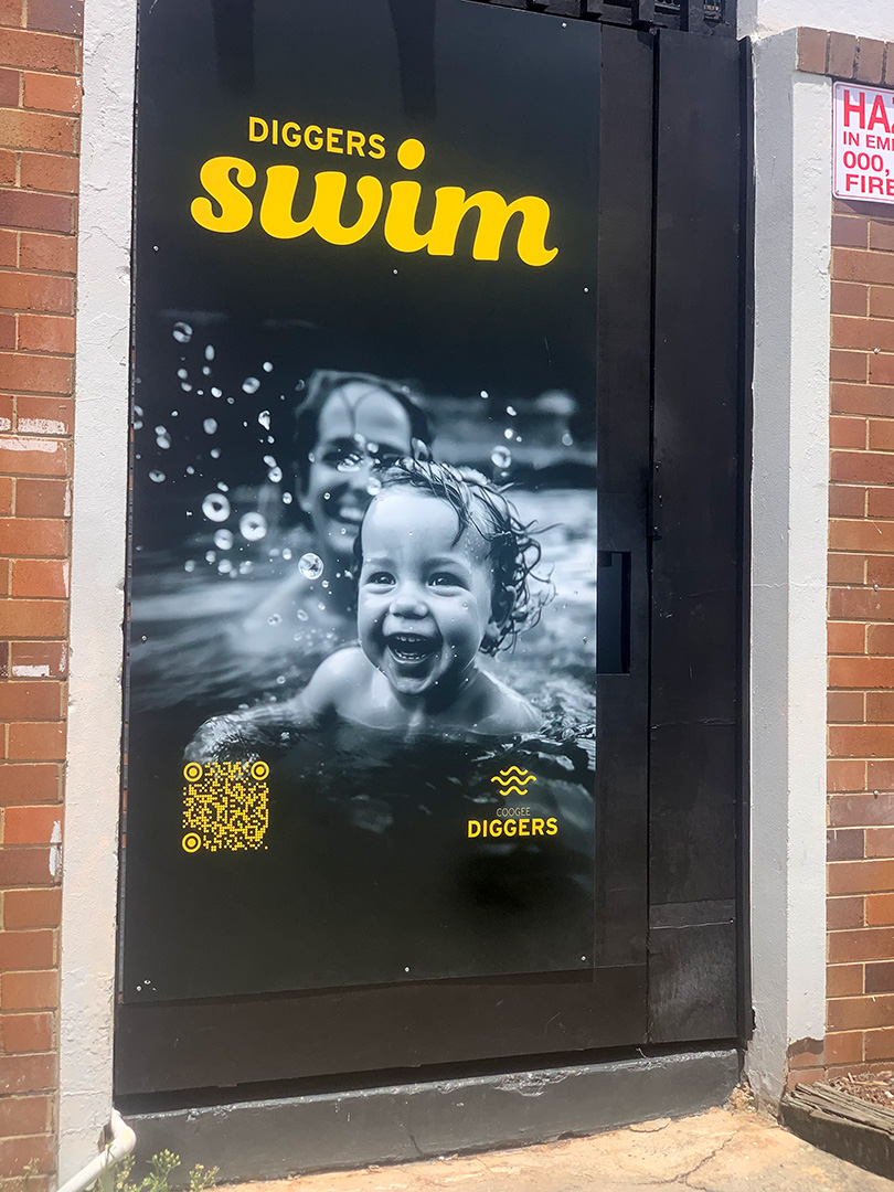 One way vision vinyl sign with an image of  people swimming