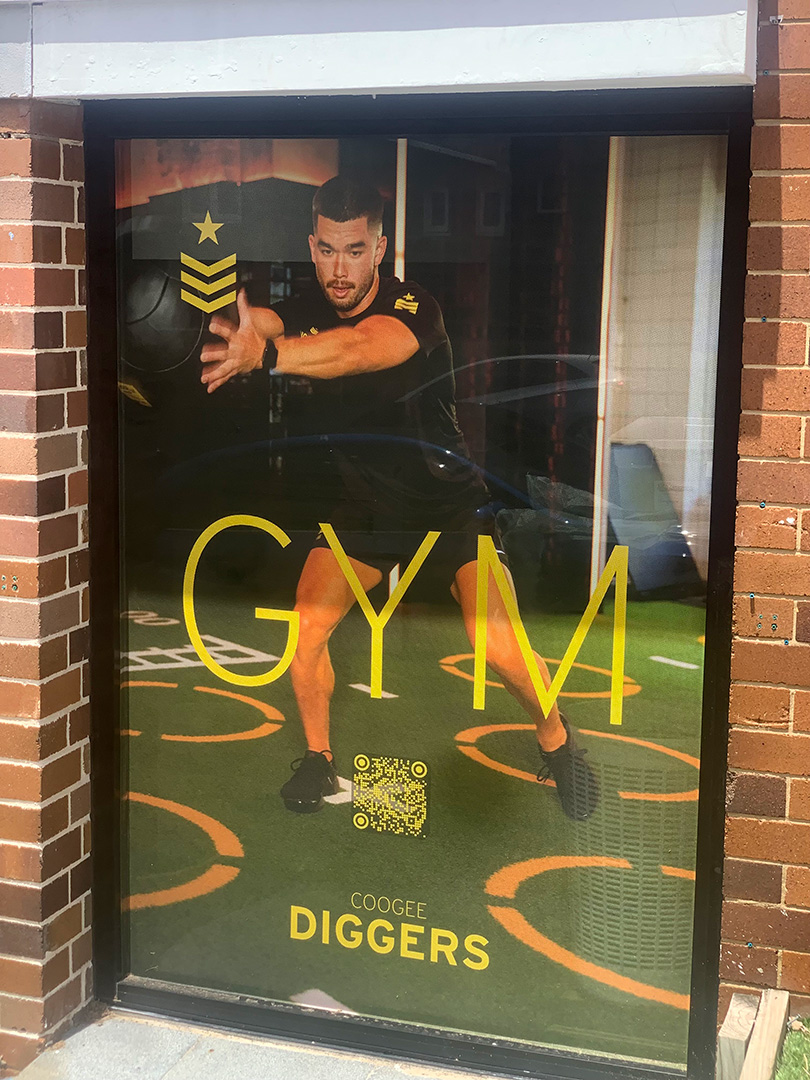 One way vision vinyl sign with a person exercising at the gym